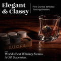 Fine crystal whiskey tasting glass with whiskey stones on a wooden coaster, labeled 'R.O.C.K.S'.