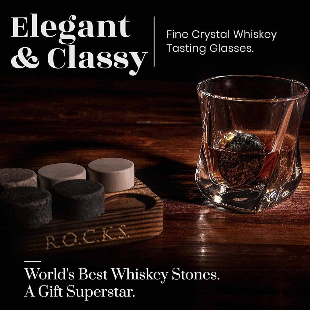Fine crystal whiskey tasting glass with whiskey stones on a wooden coaster, labeled 'R.O.C.K.S'.