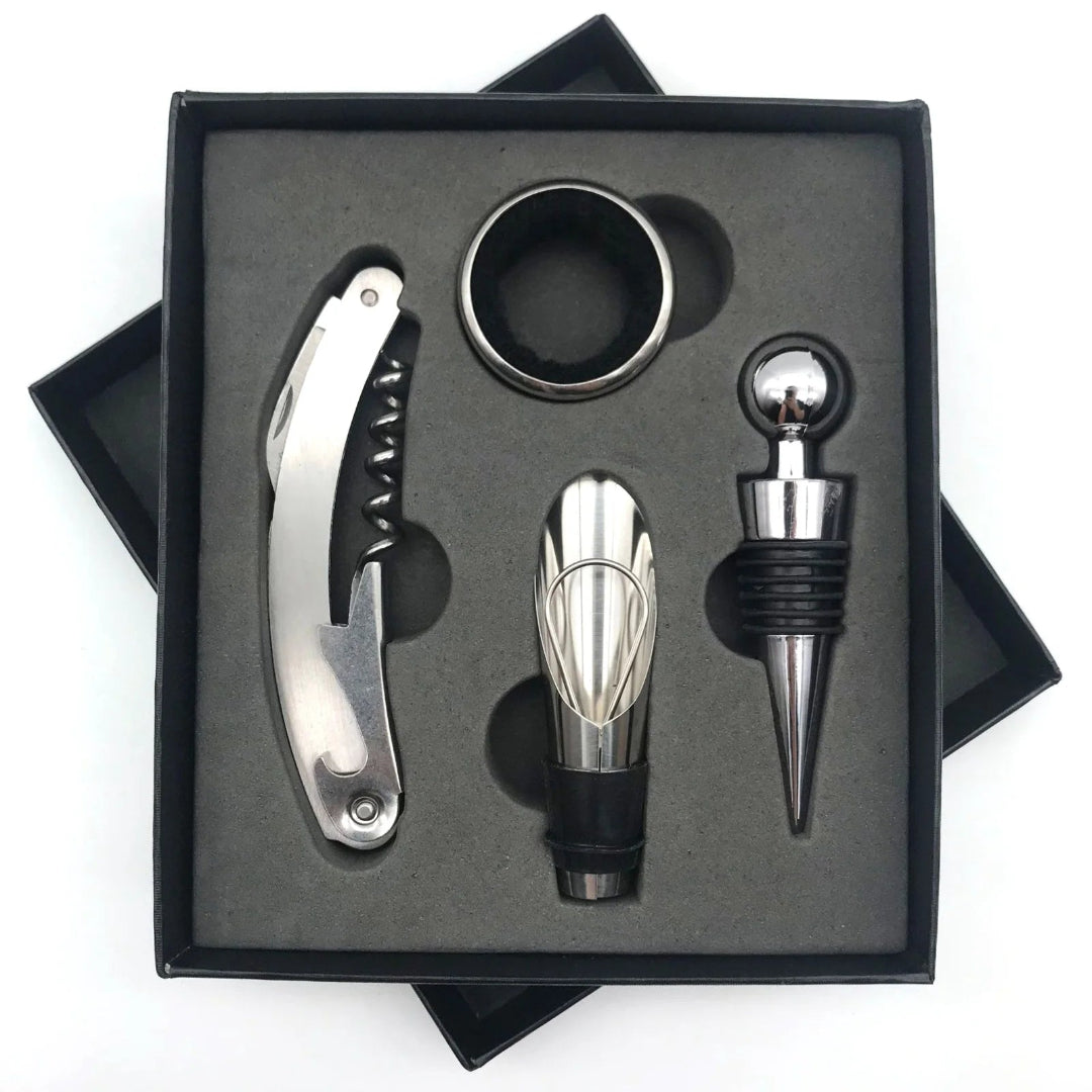 A stainless steel wine accessory set displayed in a black gift box, including a corkscrew, a wine stopper, a bottle aerator, and a round ring accessory, on a white background.