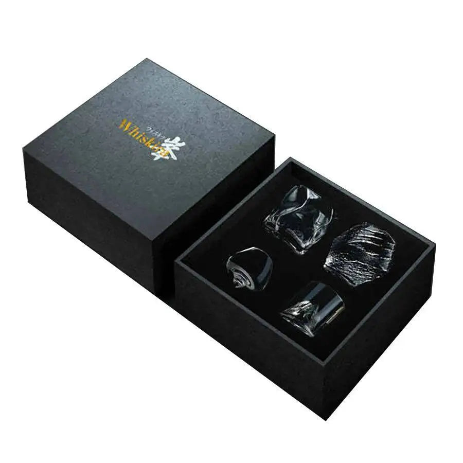 Set of four whiskey stones in a black box with a visible brand logo.