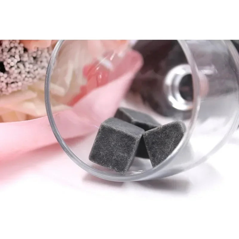 Gray cubes in a clear container with a blurred background