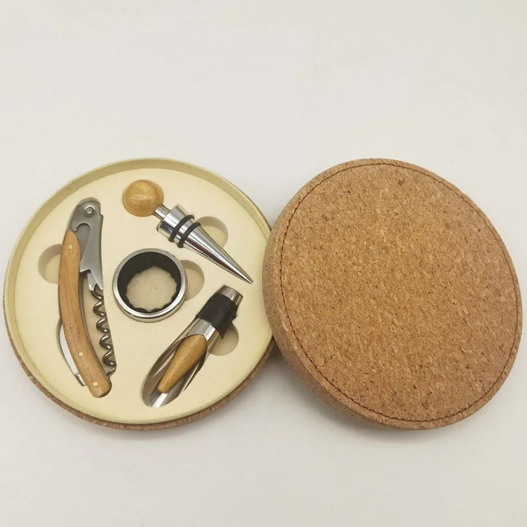 Wine tool set with corkscrew, bottle opener, and foil cutter on a cork base.
