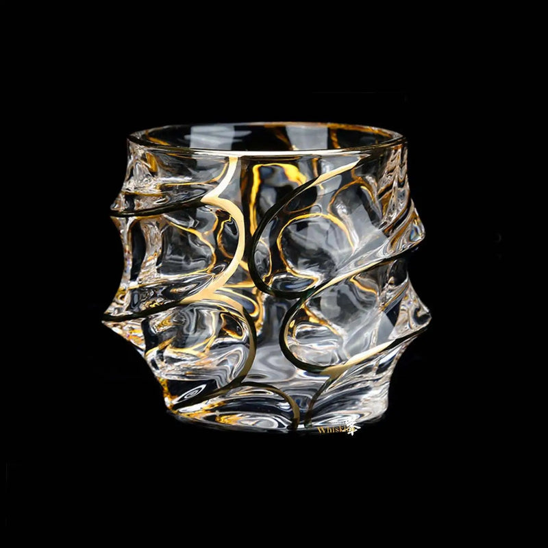 Decorative glass with gold swirls on a black background