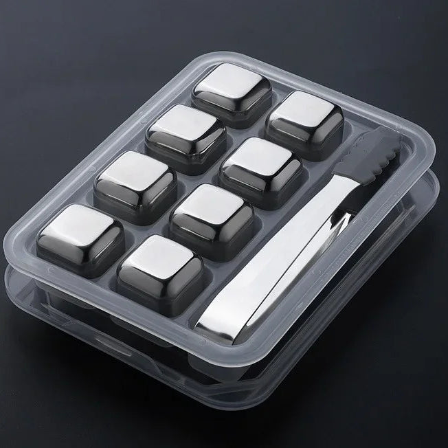 Set of square ice cubes in a clear plastic tray with a metal ice clip on a dark background.
